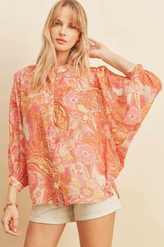 Semi-sheer paisley print collarless blouse.