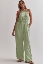 Sleeveless wide leg romper featuring dra